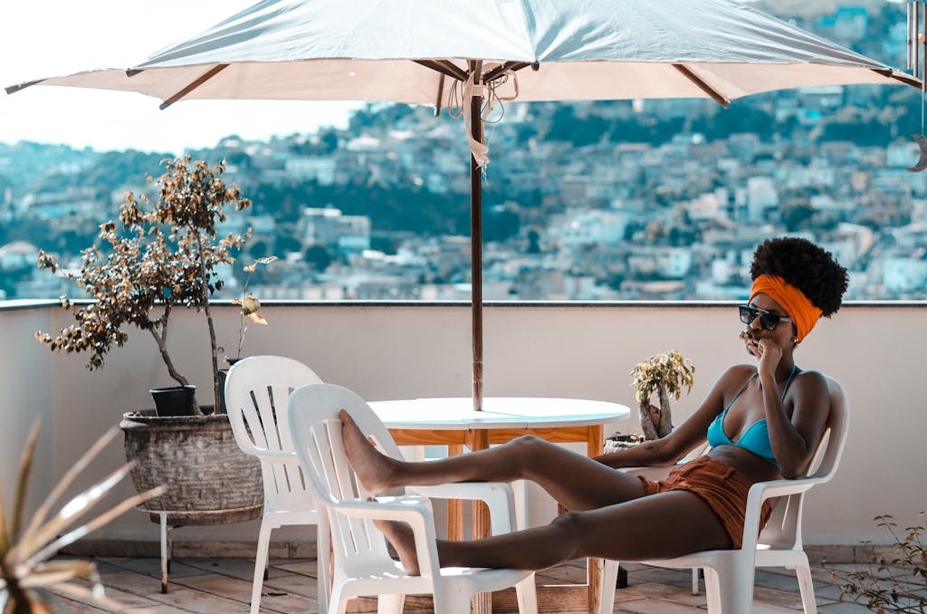 Beautify black Woman Sitting on Armchair Under White Patio Umbrella, A Black Woman’s Guide to Financial Freedom to Build Wealth