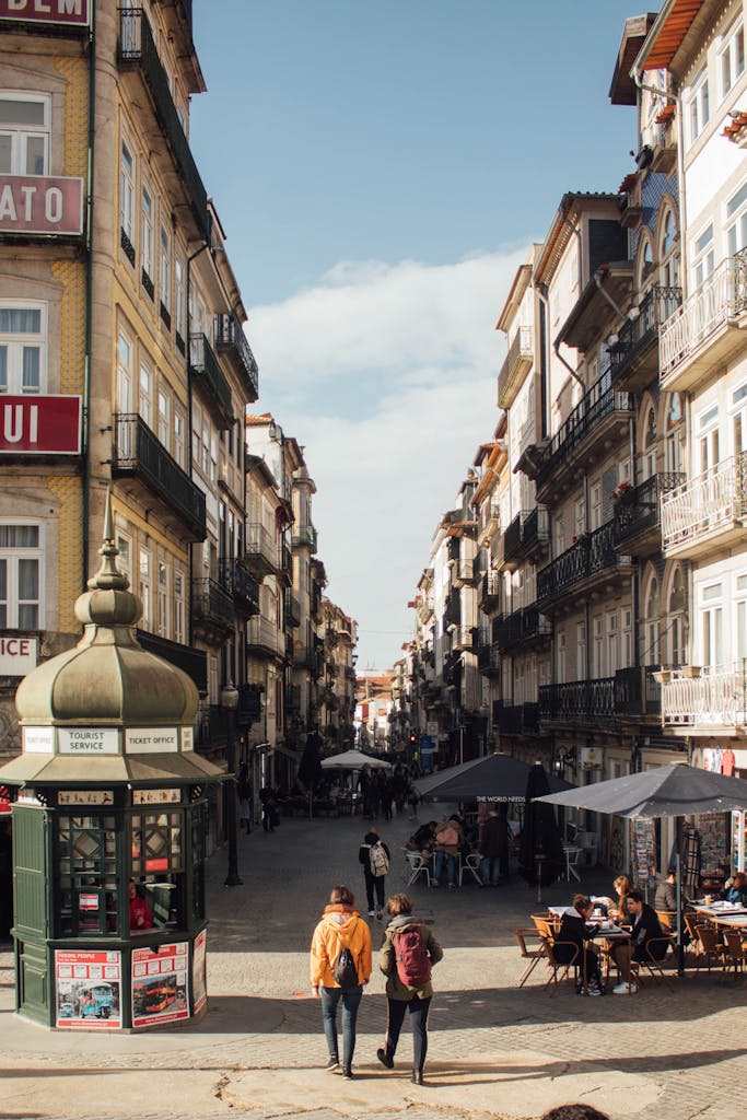 Picturesque street in Porto, Portugal, showcasing historic architecture and vibrant urban life.
