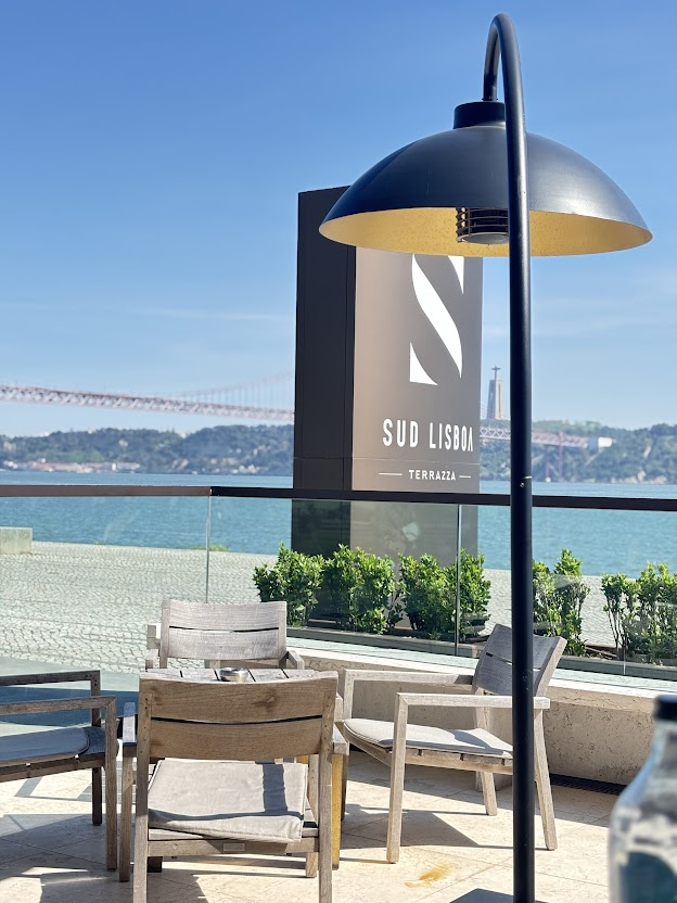 Sud Lisboa Terraza waterfront dining with Tagus River views and modern dome heater lamp on sunny day