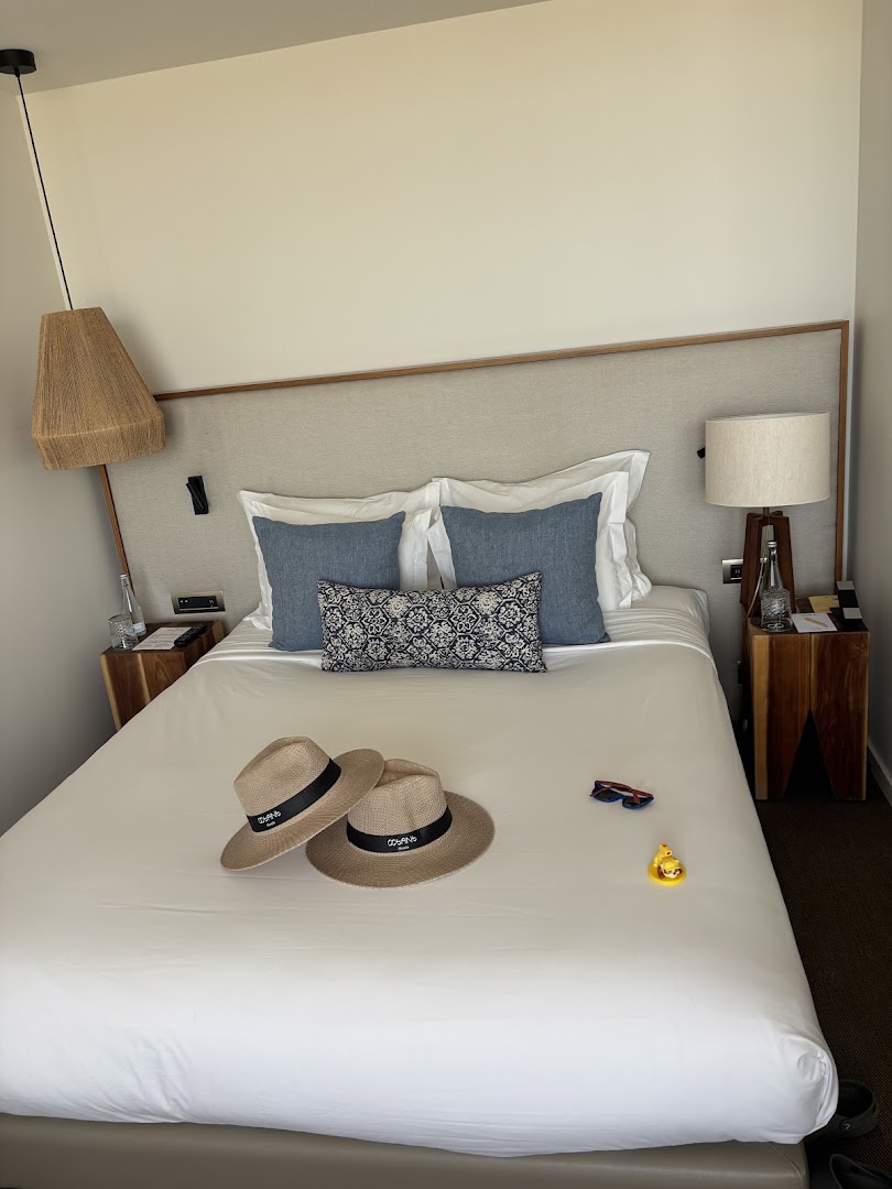 Double bed with cushions and welcome gifts in our room at Octant Évora