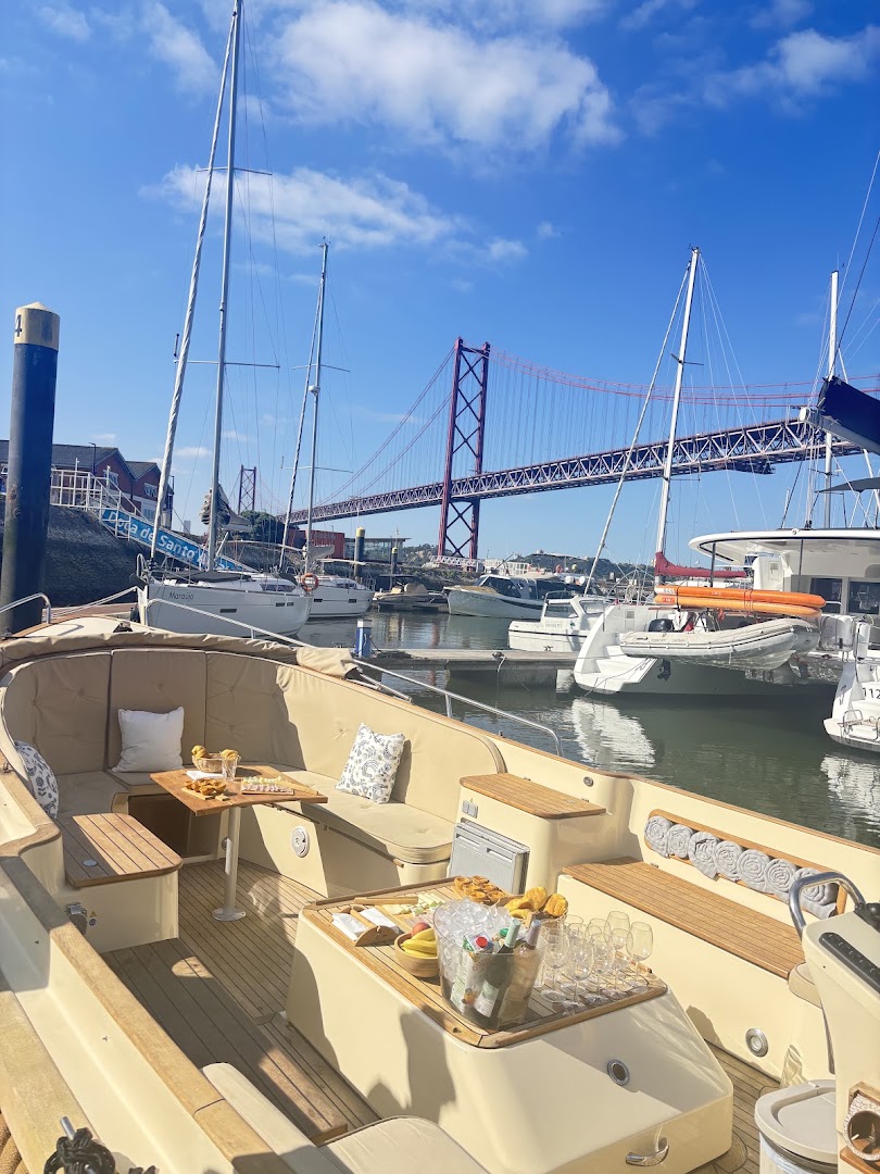 Lisbon boat at the marina with the 25 de Abril Bridge behind it