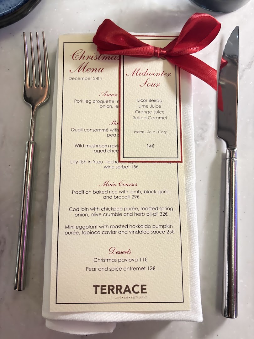 Terrace Christmas Eve menu at Martinhal Lisbon Oriente, with a red bow on a white place setting in December 2025