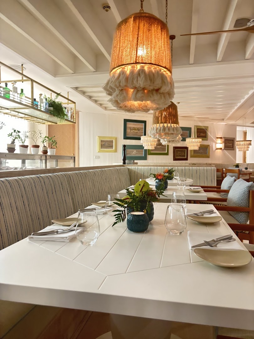 Set dining tables, upholstered seating, and pendant lights at Vila Vita Parc.
